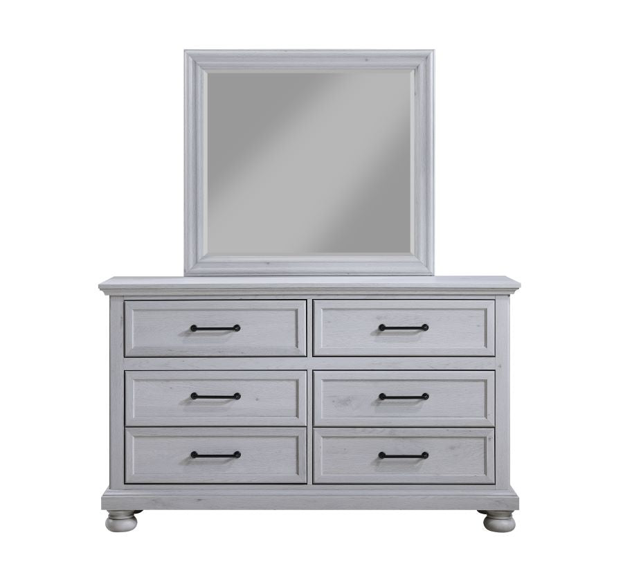 Bedroom mirror with dove gray frame on dresser with six drawers and black pulls