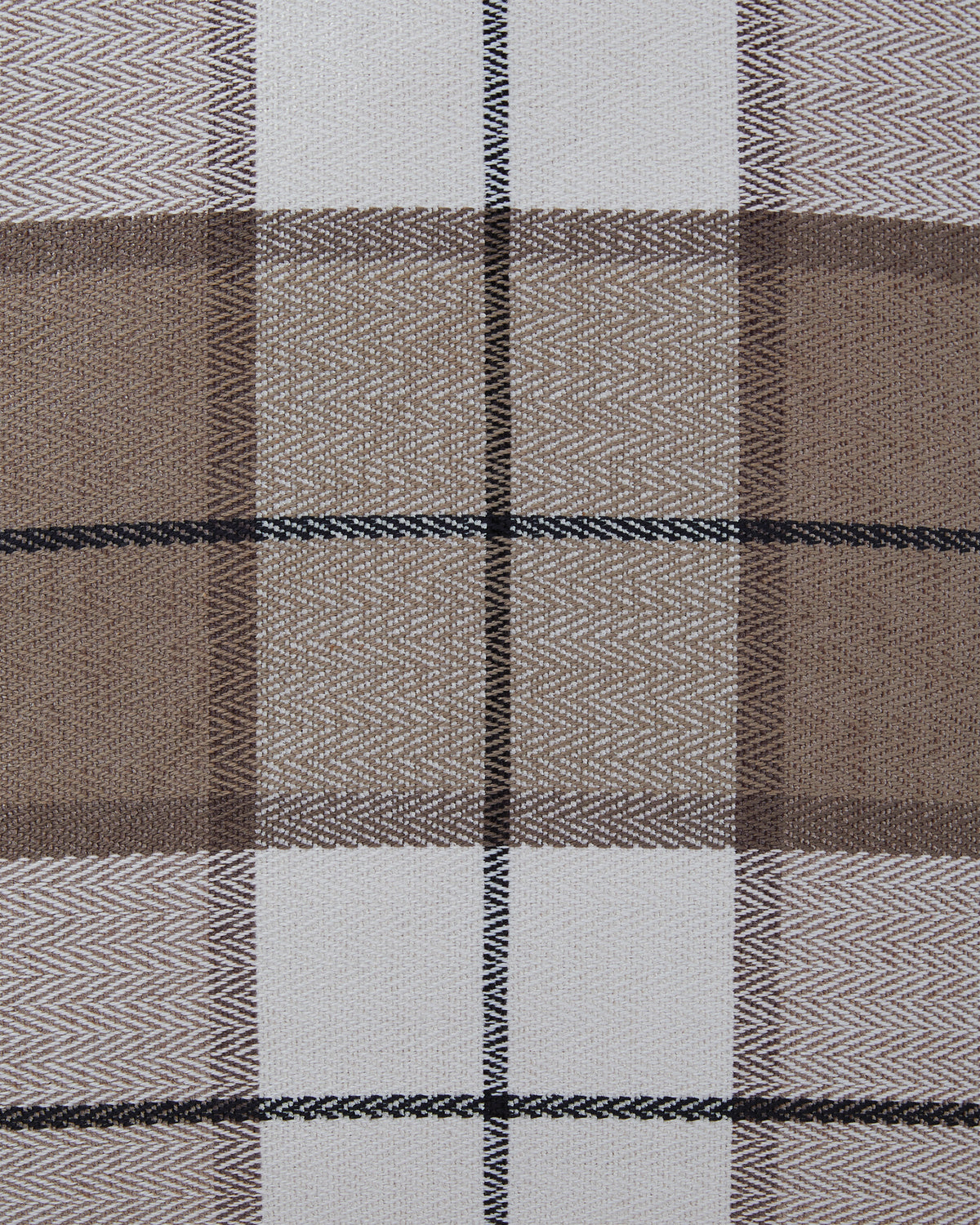 Close-up plaid pillow fabric with brown, taupe, white, and dark blue grid