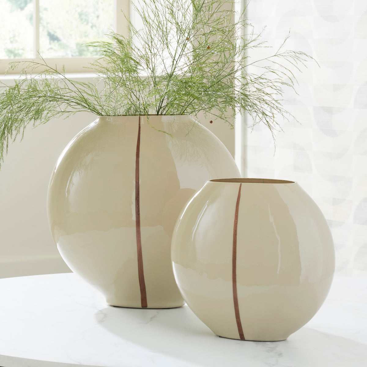 Cream ceramic vase set with tall and short rounded shapes, each with vertical brown stripe.