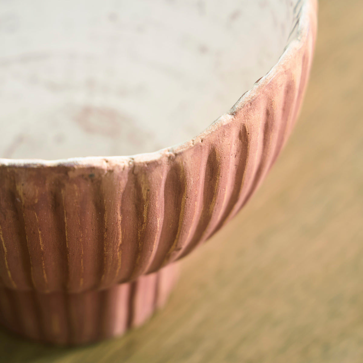 Close-up of ribbed terracotta vase rim and side detail