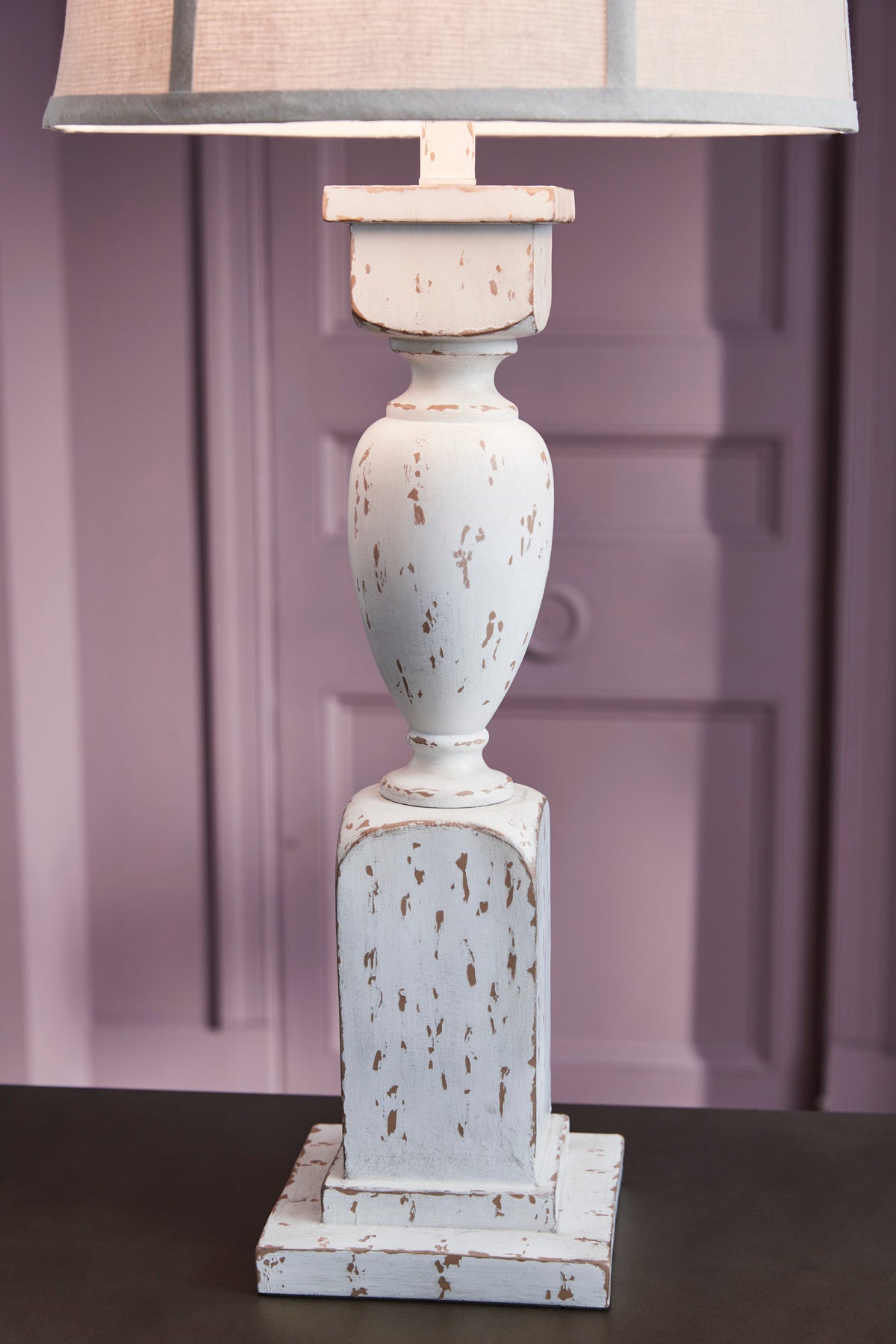 Cream speckled ceramic table lamp base with beige drum shade and stacked pedestal
