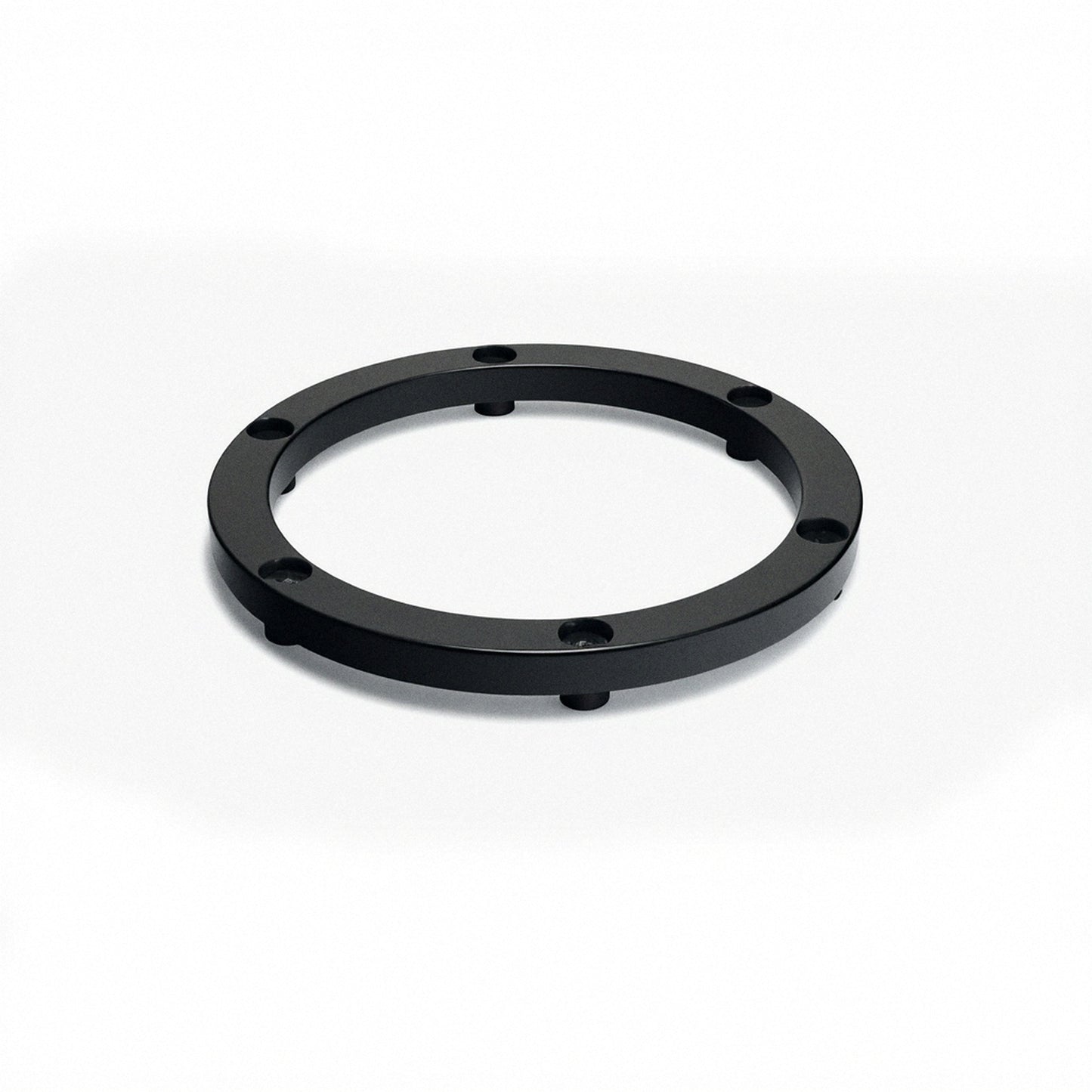 Black circular elevator ring base with four small legs and mounting holes
