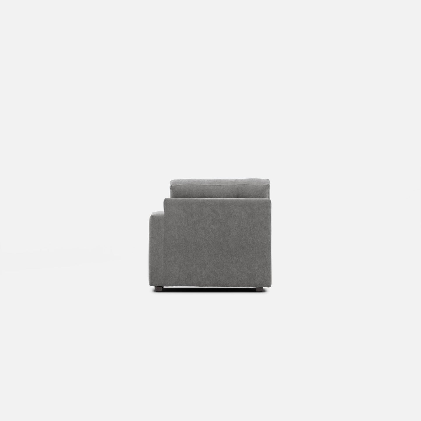 Gray upholstered modular chair viewed from the side, with thick back cushion
