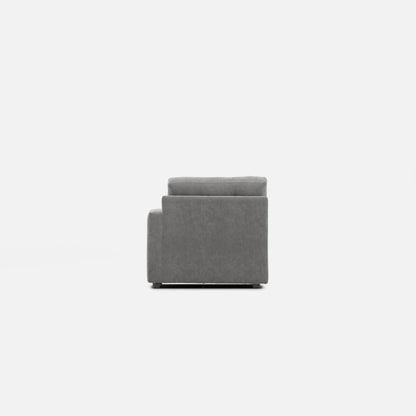 Gray upholstered modular chair viewed from the side, with thick back cushion