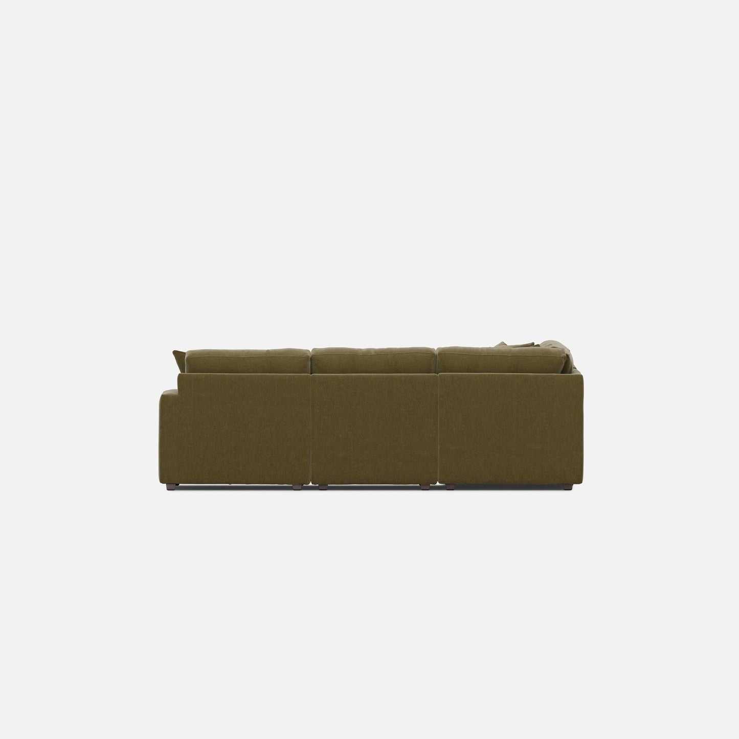 Olive green sectional sofa from the side with wide armrests and tufted cushion backs