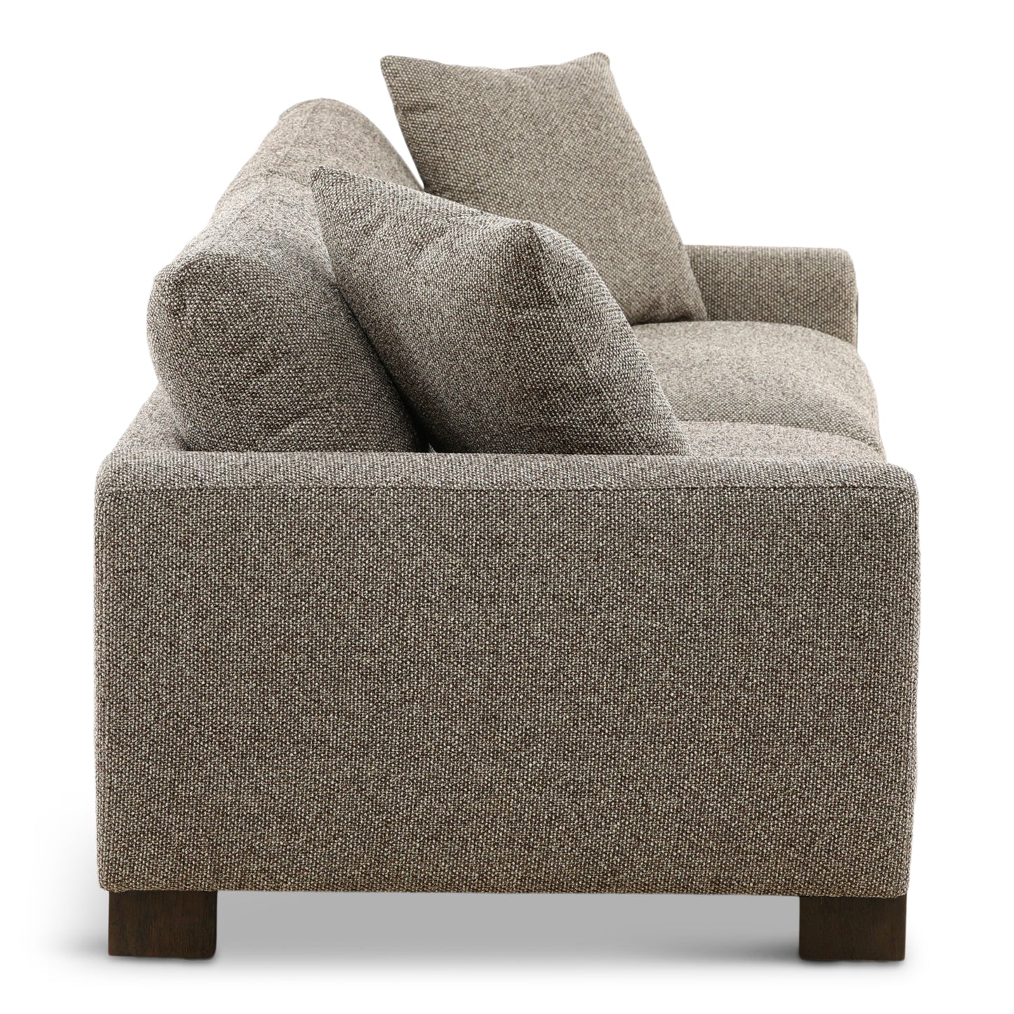 Gray fabric sofa backrest with three tall throw pillows and textured upholstery.
