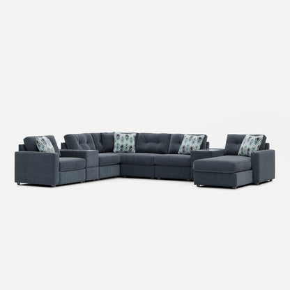 Gray modular sectional sofa with patterned lumbar pillows and corner chaise seating