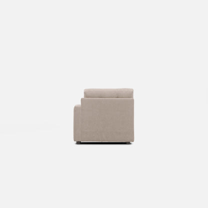 Beige modular chair seen from front, square arms and padded backrest