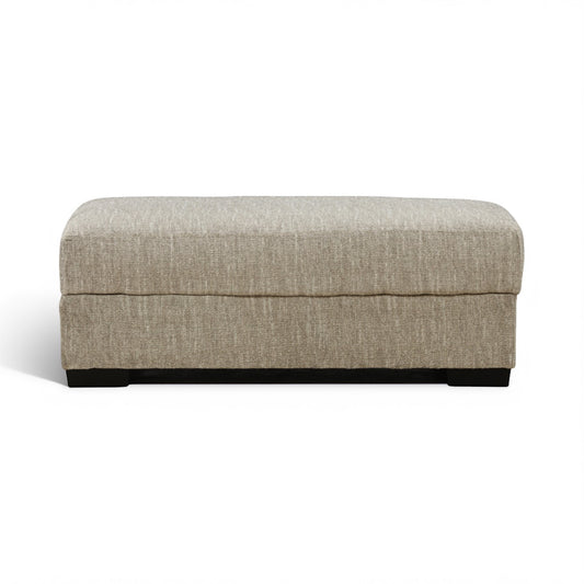 Rectangular storage ottoman with light beige upholstery and dark base feet