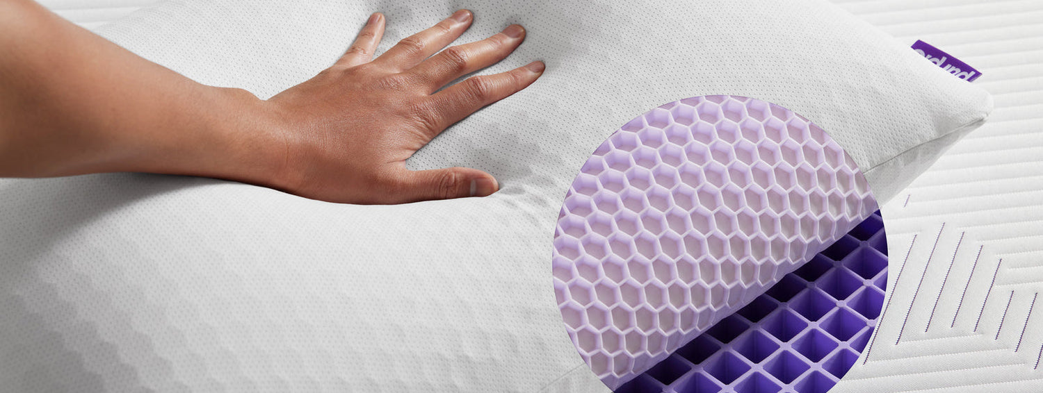 Hand touching a textured pillow with a purple and blue design