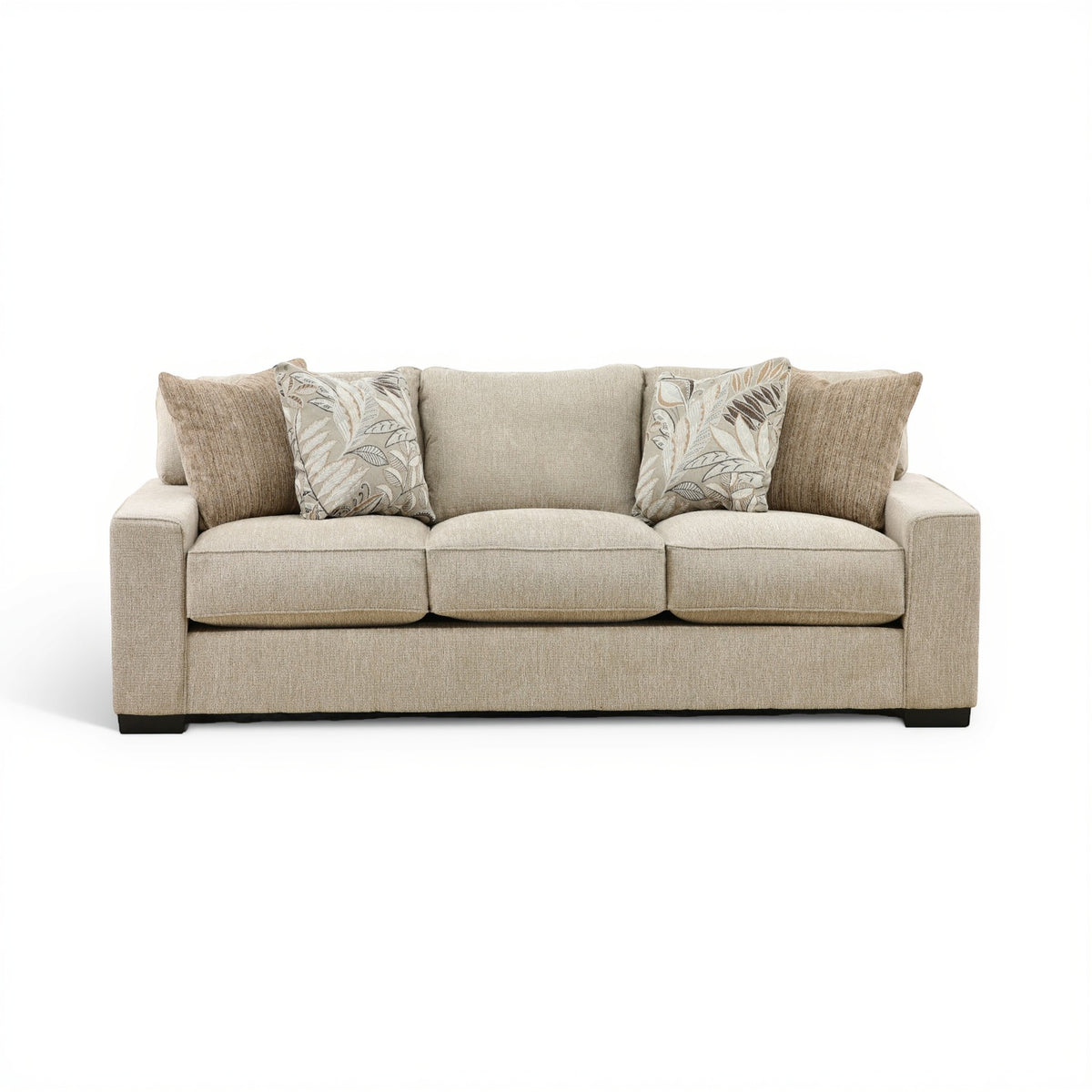 Beige fabric three-seat sofa with two patterned throw pillows and square arms