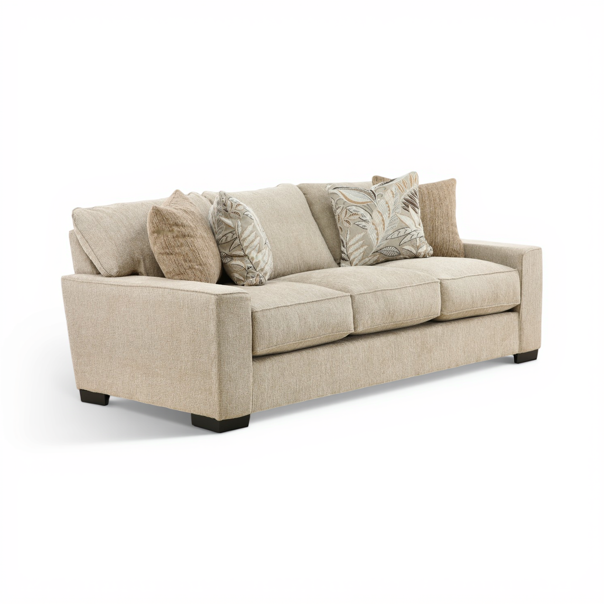 Beige fabric three-seat sofa, side view with low black feet and three throw pillows