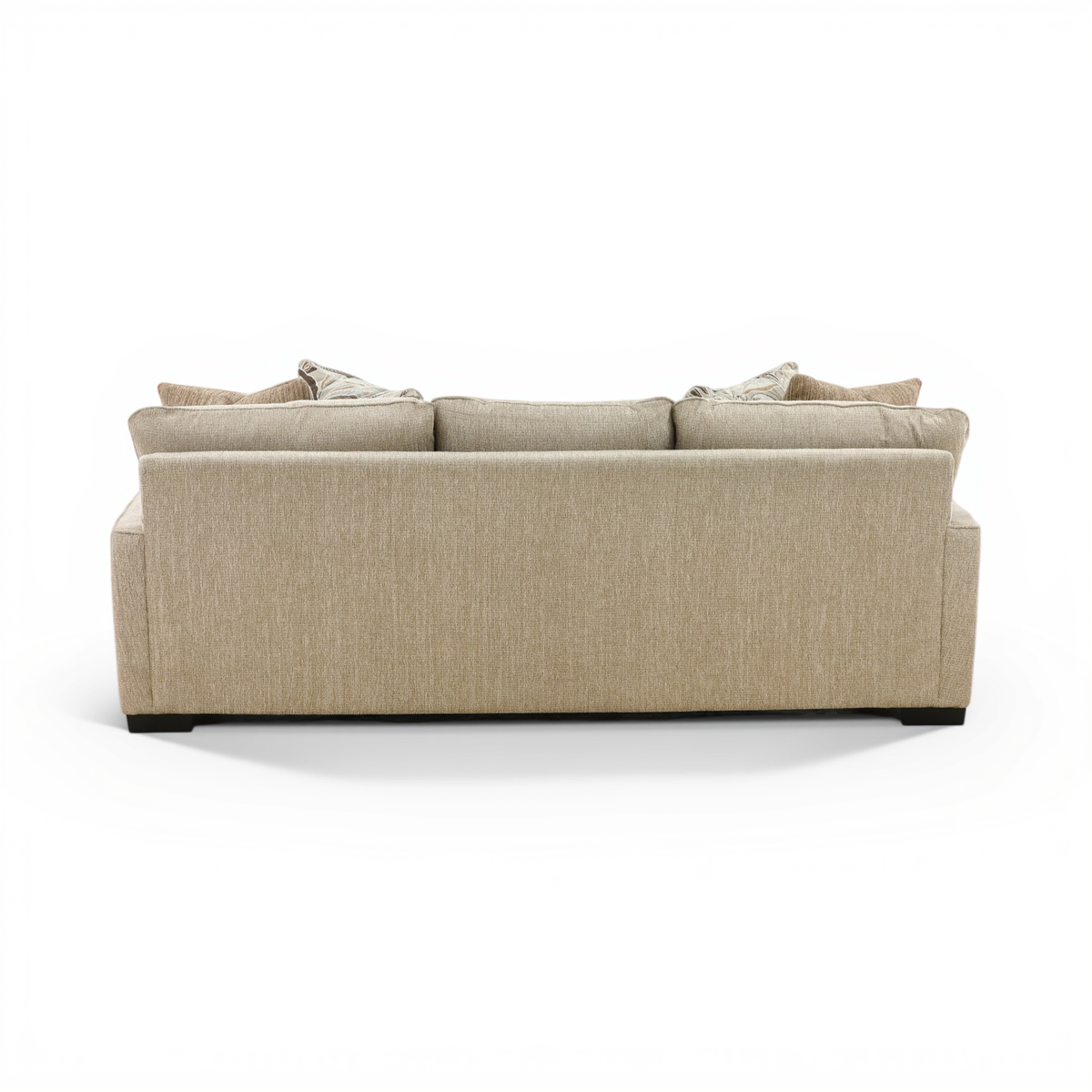 Beige fabric three-seat sofa back view with stacked throw pillows and low black feet