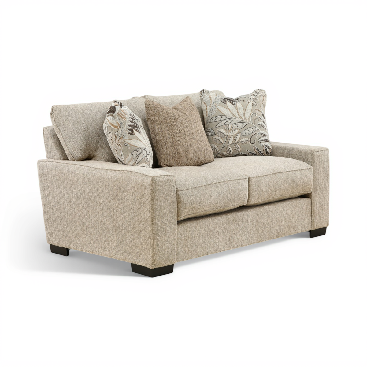 Light beige two-seat loveseat with three back cushions and two leaf-print throw pillows