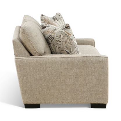 Light beige loveseat with two accent pillows on deep seat and dark block feet