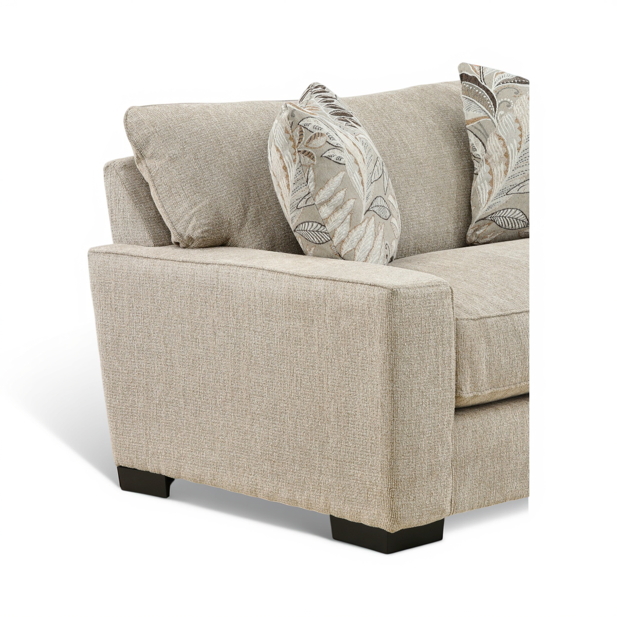 Beige upholstered chair with three back pillows and dark foot legs