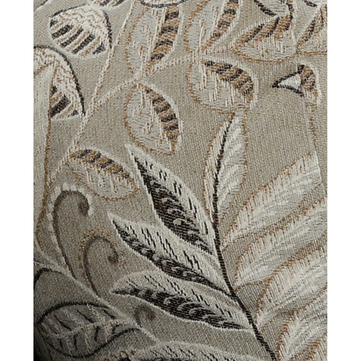 Close-up of leaf-pattern accent pillow fabric in beige, gray, and dark tones