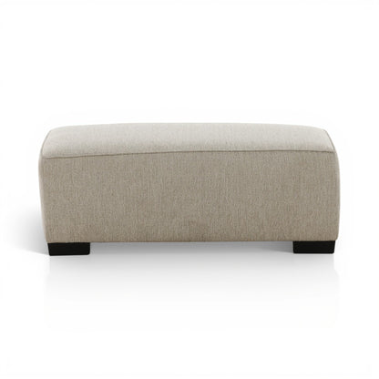 Upholstered ottoman with light beige fabric and black block legs