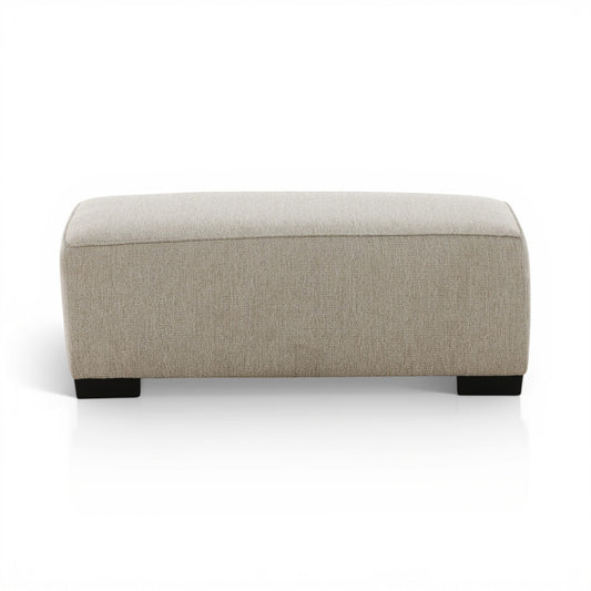 Upholstered ottoman with light beige fabric and black block legs