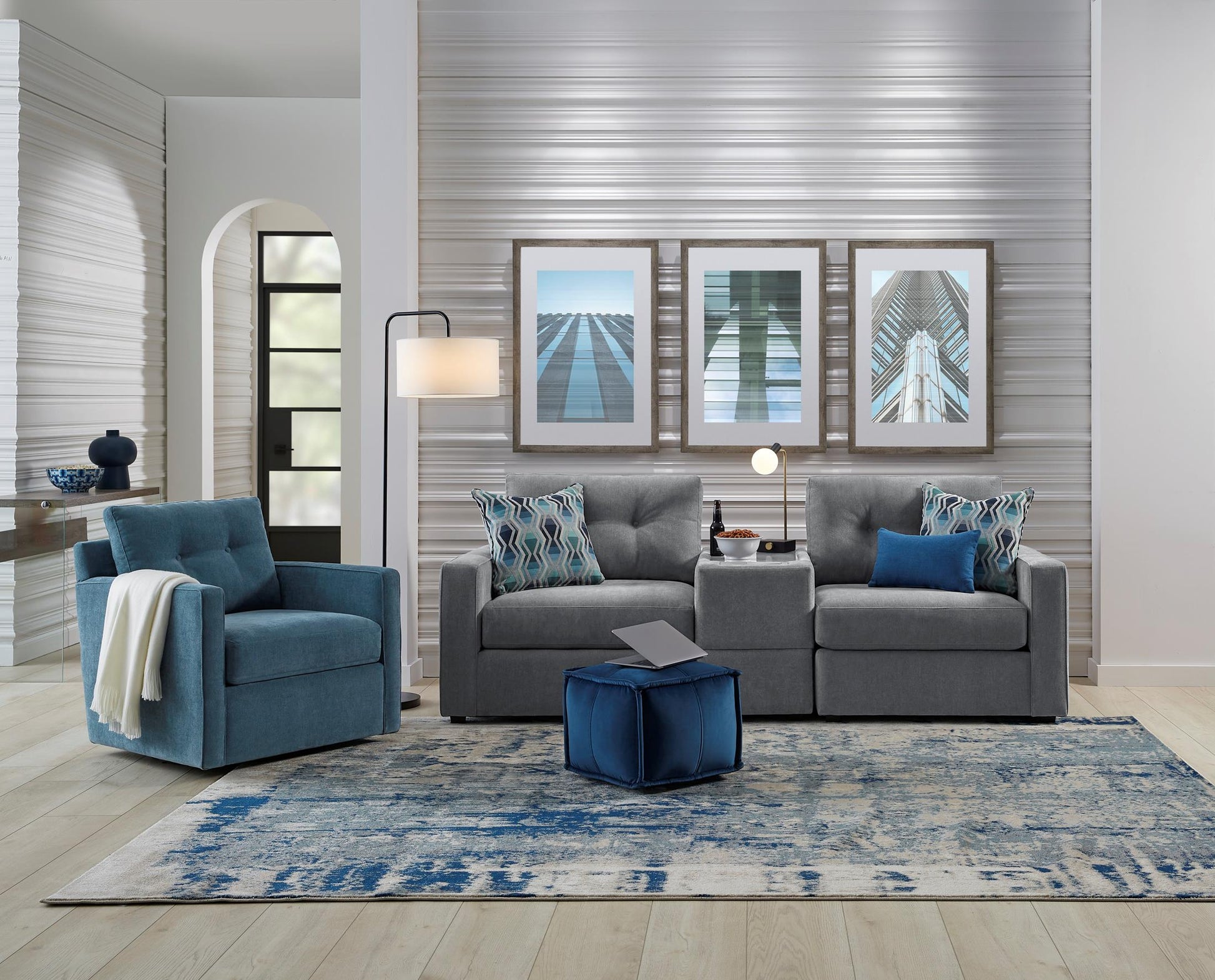 Gray modular console loveseat with three-seat layout, armrests, and two back pillows