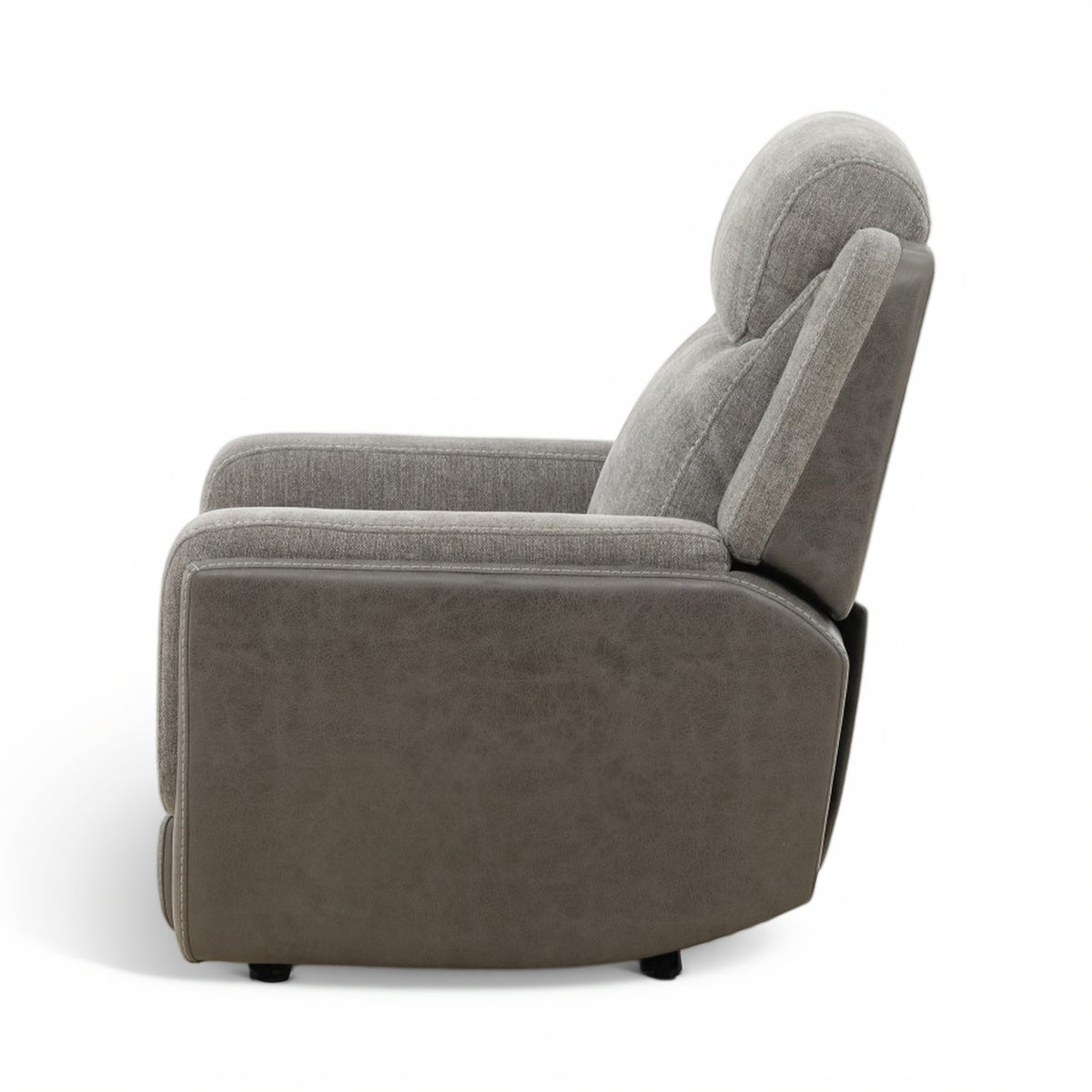 Grey power recliner chair from the side, showing wide arm padding and rounded back.