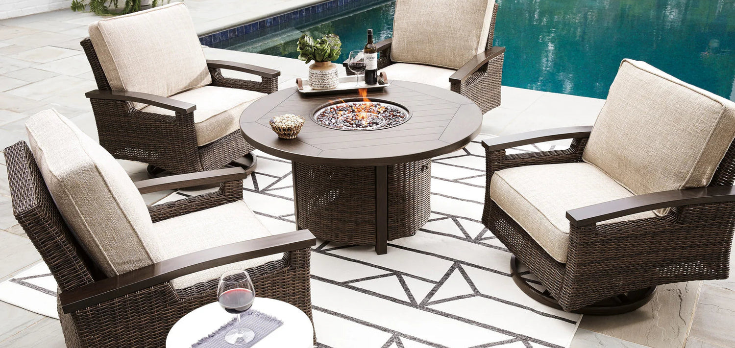 Outdoor patio set with chairs and a fire pit table by a pool.