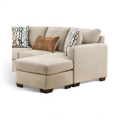Parchment corner chaise with seat and patterned plus tan accent pillows