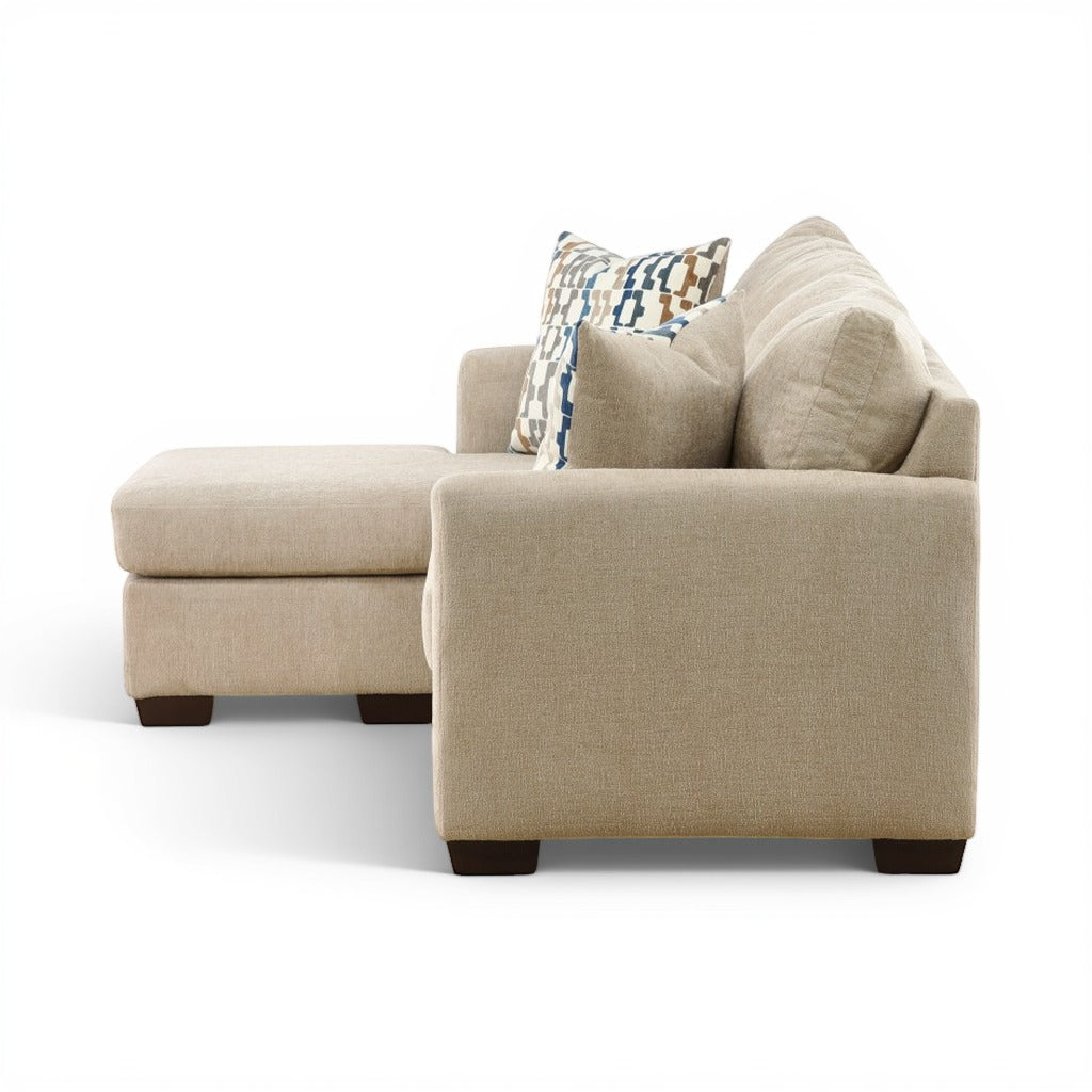 Parchment chaise sofa with tufted back cushions and decorative geometric pillows