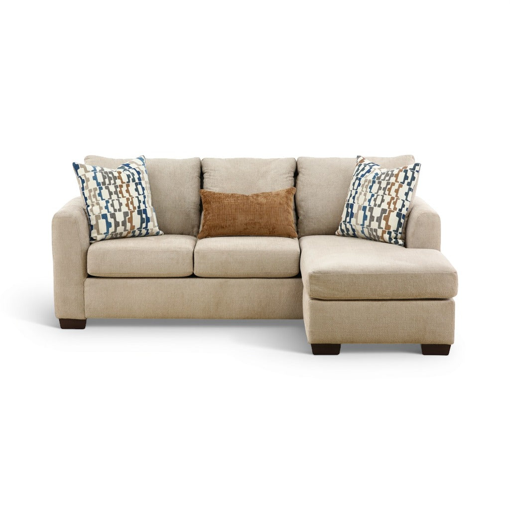 Parchment sofa chaise with chaise ottoman and patterned throw pillows; includes brown accent cushion.