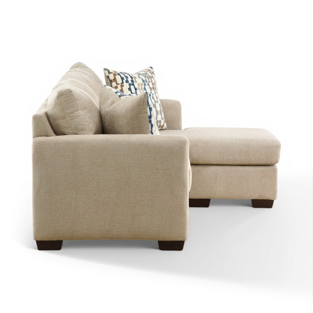 Parchment chaise sofa with track arms and geometric throw pillow