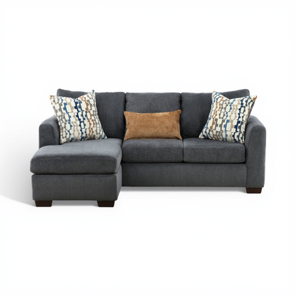 Charcoal sofa chaise with chaise extension and patterned accent pillows.