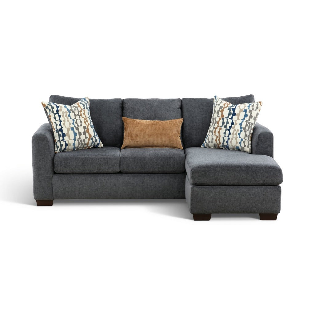 Charcoal sofa chaise with chaise ottoman, two patterned pillows, and a brown accent cushion.