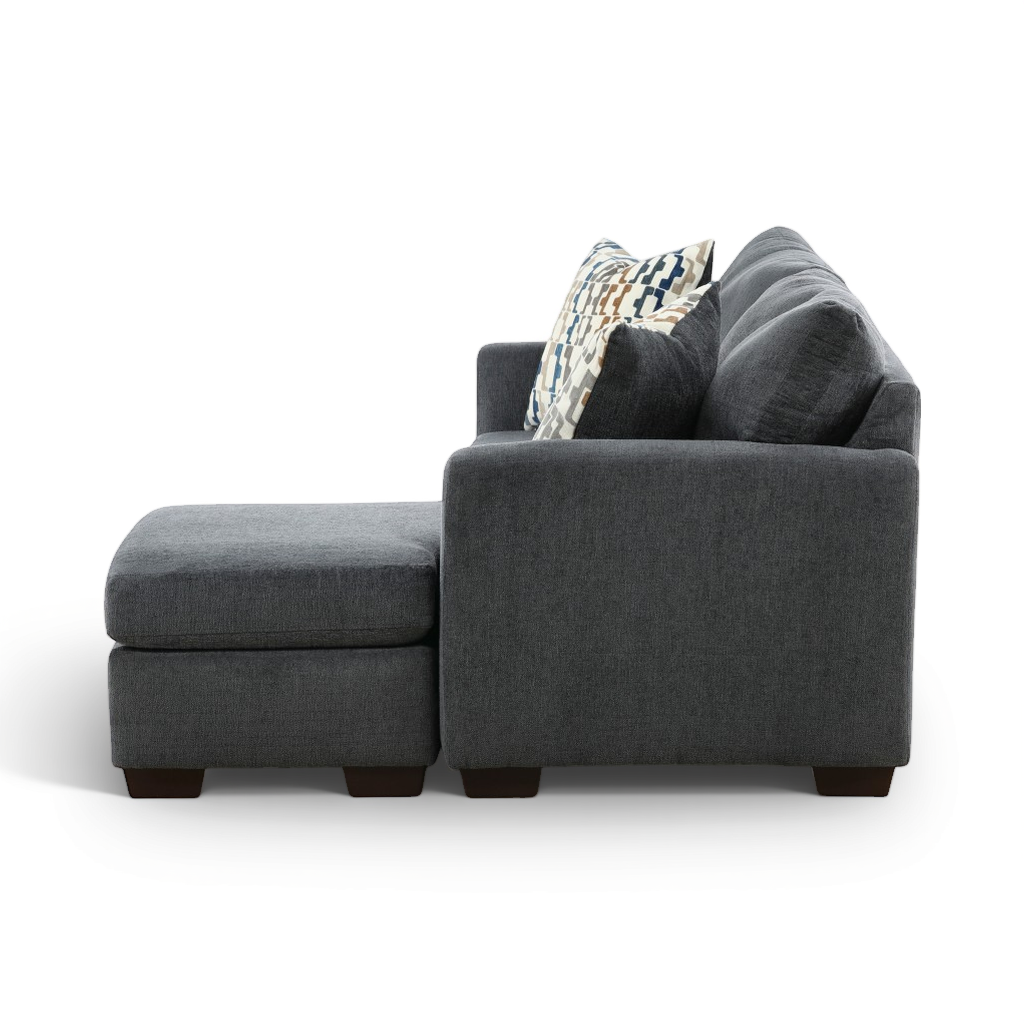 Charcoal sofa chaise with chaise extension, armrest and patterned throw pillow.