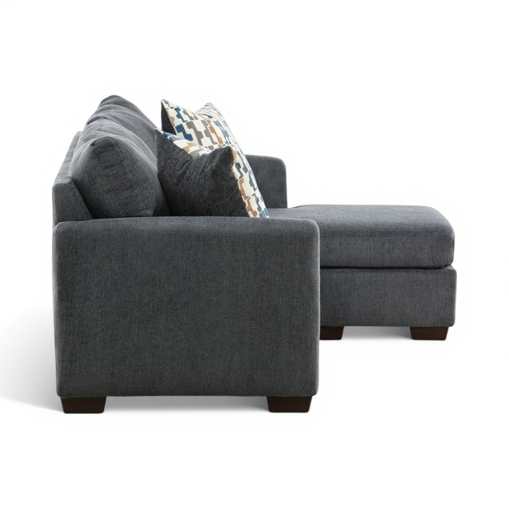 Charcoal sofa chaise corner view with throw pillows on chaise end.