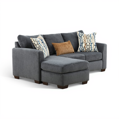 Charcoal sofa chaise with chaise ottoman and patterned accent pillows.