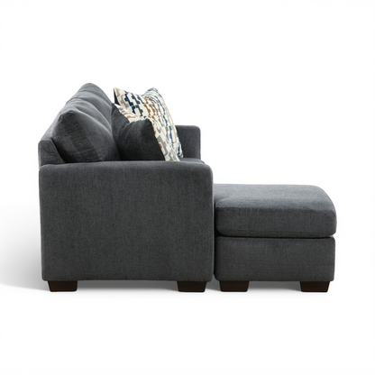 Charcoal sofa chaise with chaise side, textured fabric and accent pillows.