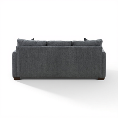 Charcoal sofa chaise from front, three back cushions and dark legs.