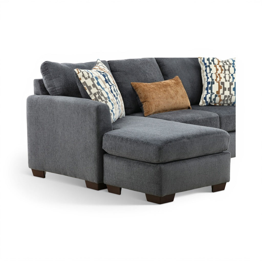 Charcoal chaise sofa with geometric pillows and tan accent cushion
