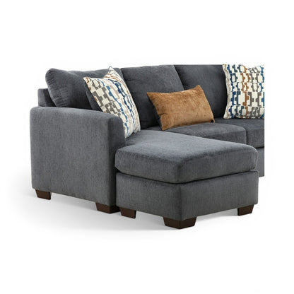 Charcoal chaise sofa with geometric pillows and tan accent cushion