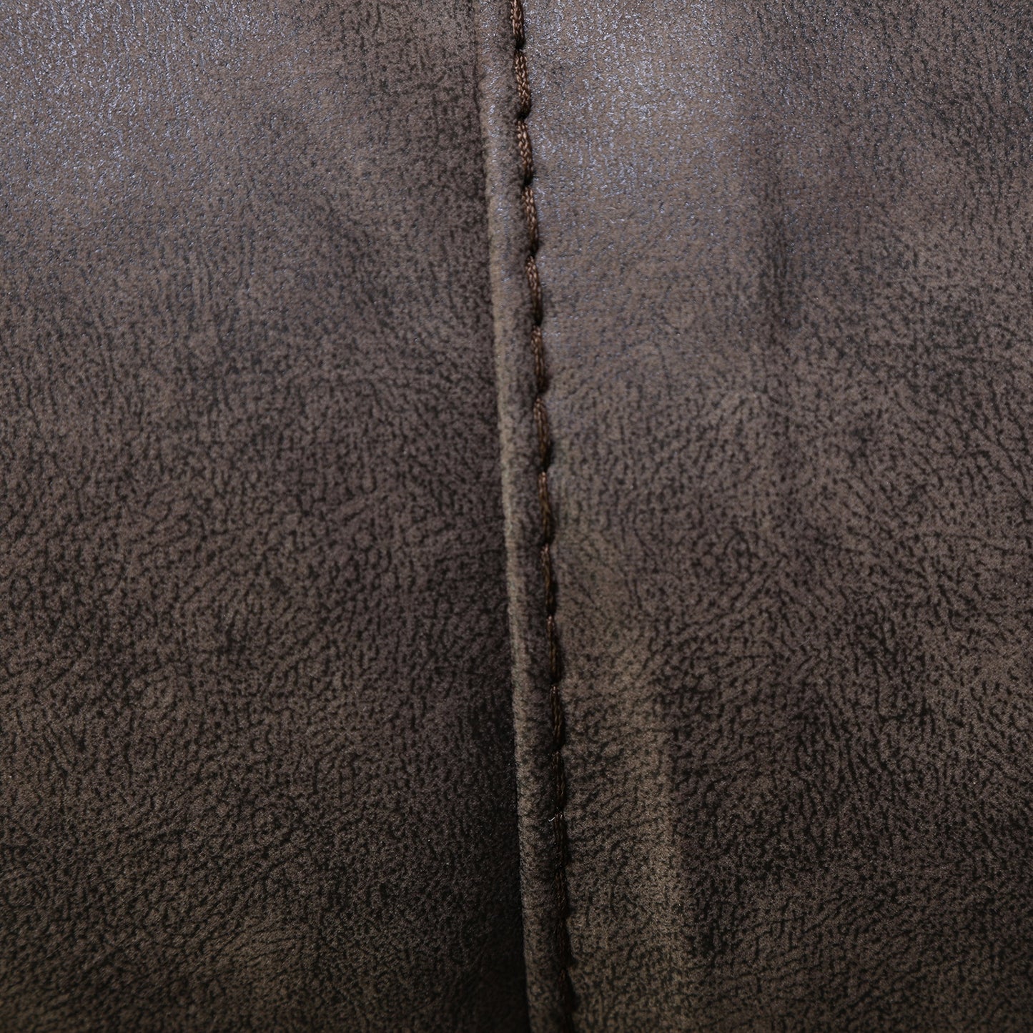 Dark brown upholstery with vertical seam and stitched edge detail