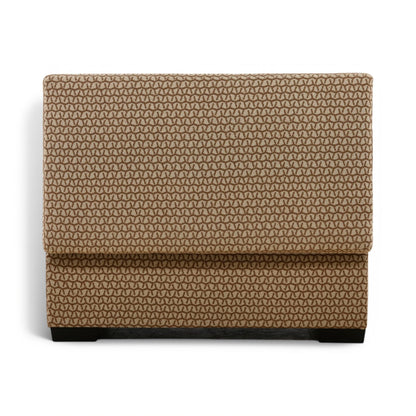 Tan storage ottoman with dark geometric pattern and closed hinged lid