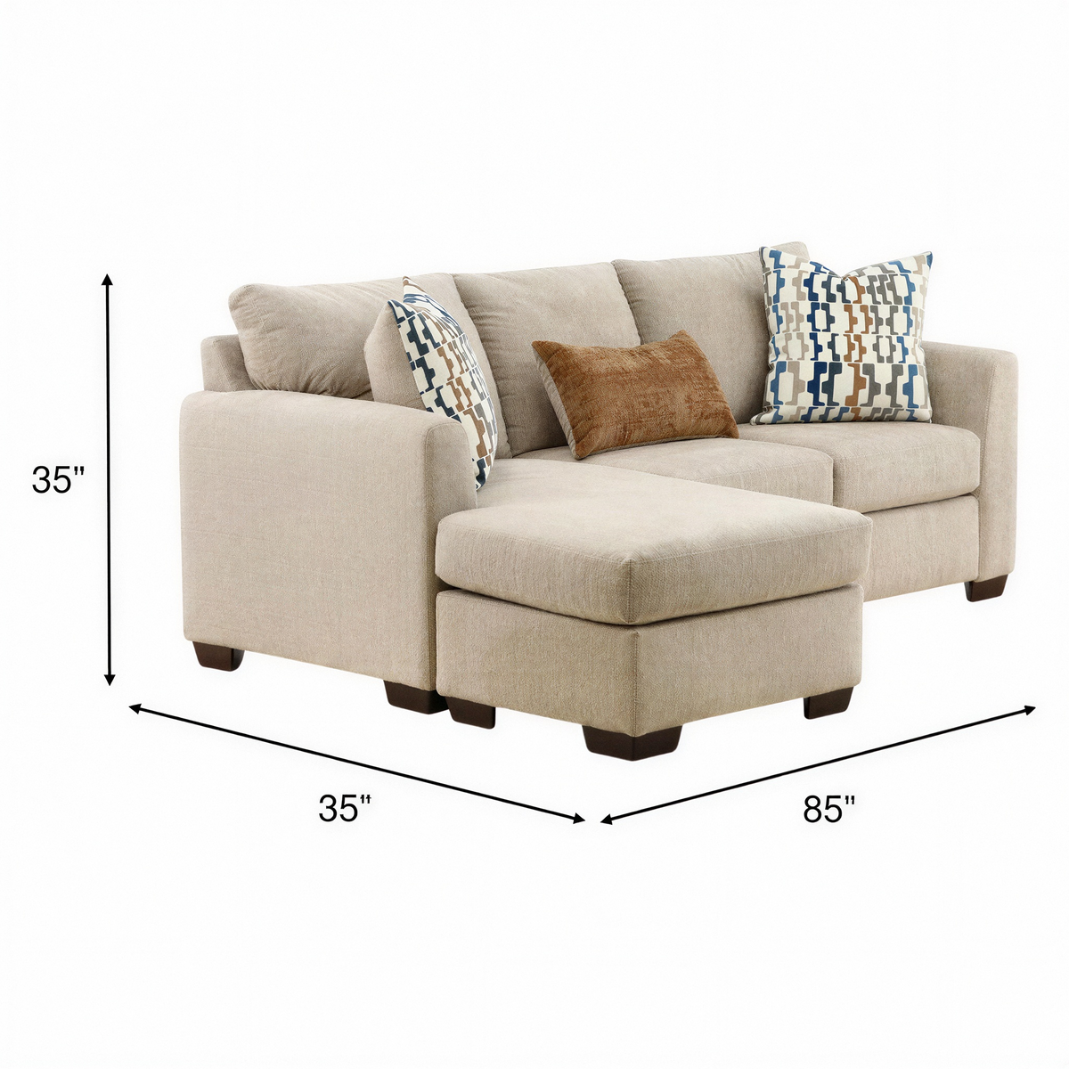 Parchment sofa chaise with cushioned chaise, dark legs, and patterned throw pillows