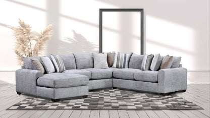 Gray chaise sectional sofa with tufted seat cushions and striped accent pillows