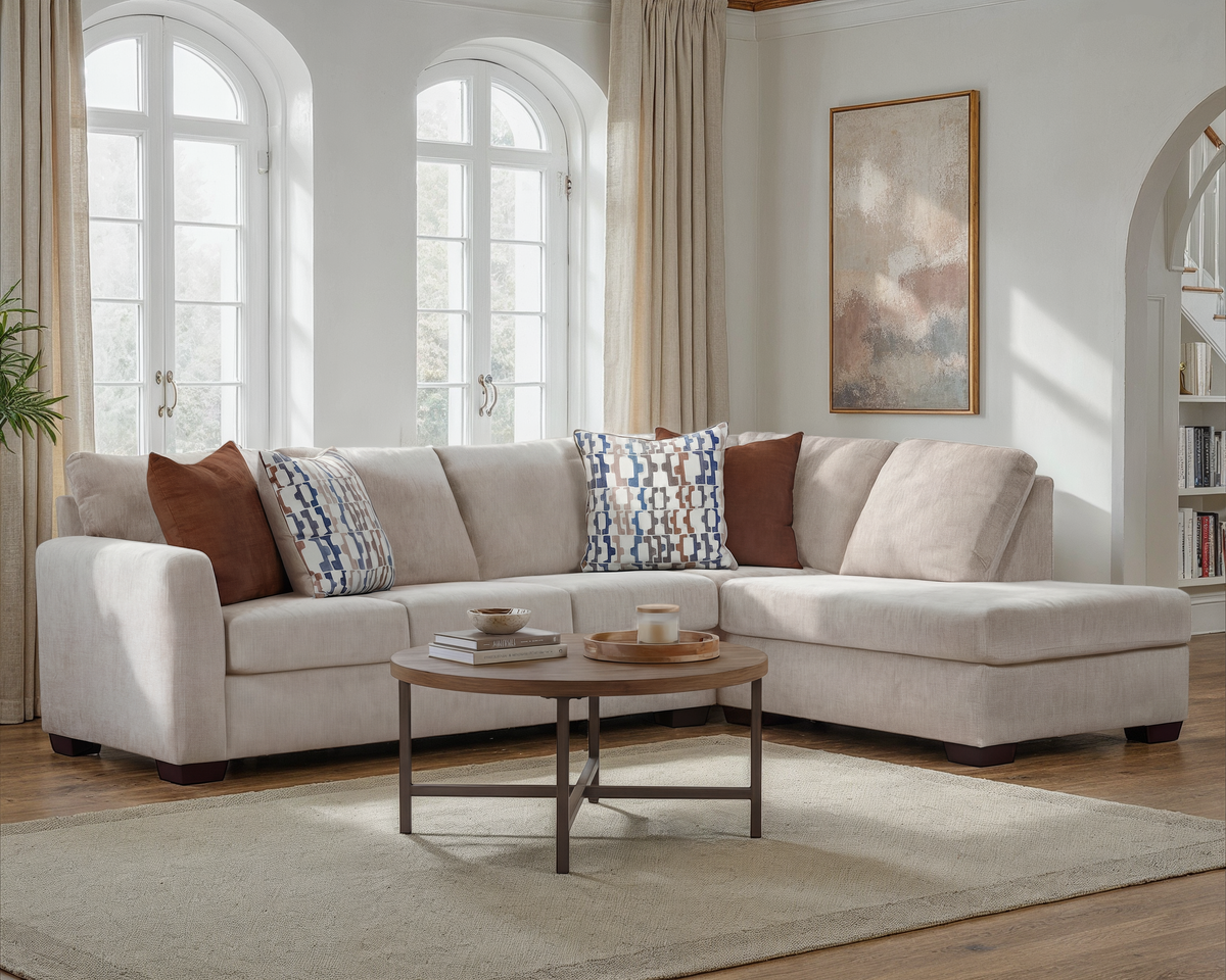 Beige fabric sectional sofa with right chaise, corner seat and patterned throw pillows