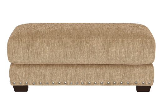Sand fabric ottoman with tufted top, studded trim, and dark wooden legs