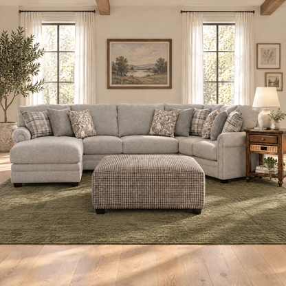 Light gray sectional sofa with patterned pillows, chaise and matching ottoman