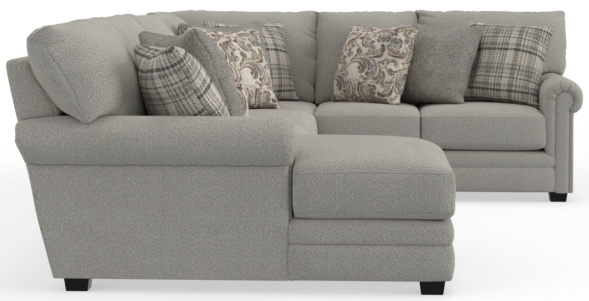 Light gray sectional sofa with built-in chaise and patterned accent pillows