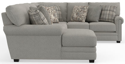 Light gray sectional sofa with built-in chaise and patterned accent pillows