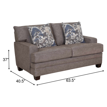 Gray upholstered loveseat with two seat cushions and floral accent throw pillows