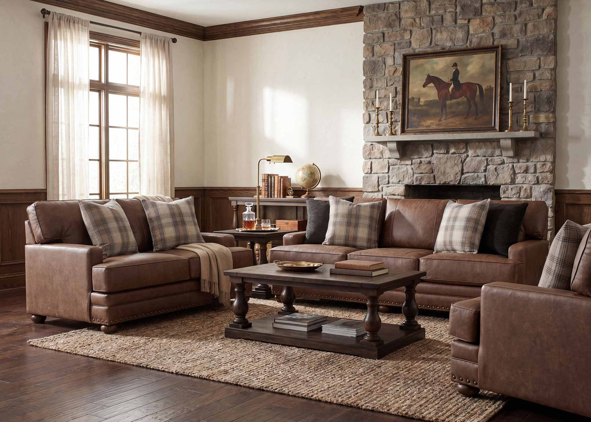 Brown upholstered chair with plaid pillow and nailhead trim, front corner view